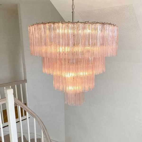 Italian murano chandelier casting warm pink light in modern interior