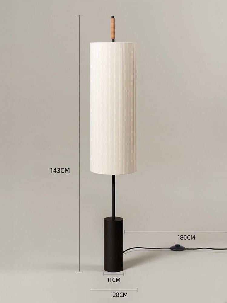 Contemporary fabric floor lamp creating ambient lighting in bedroom