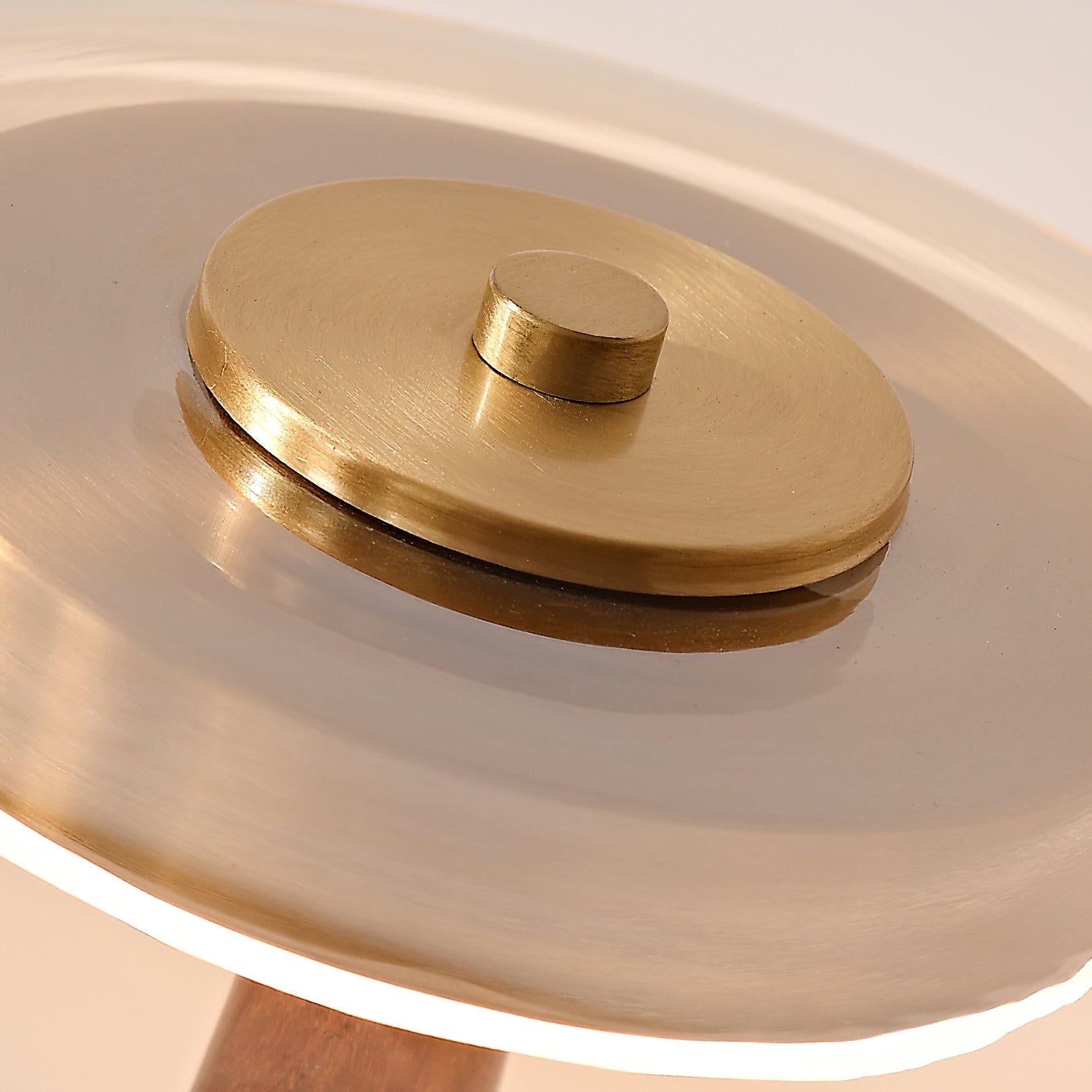Modern table lamp displaying premium walnut construction and brass detailing