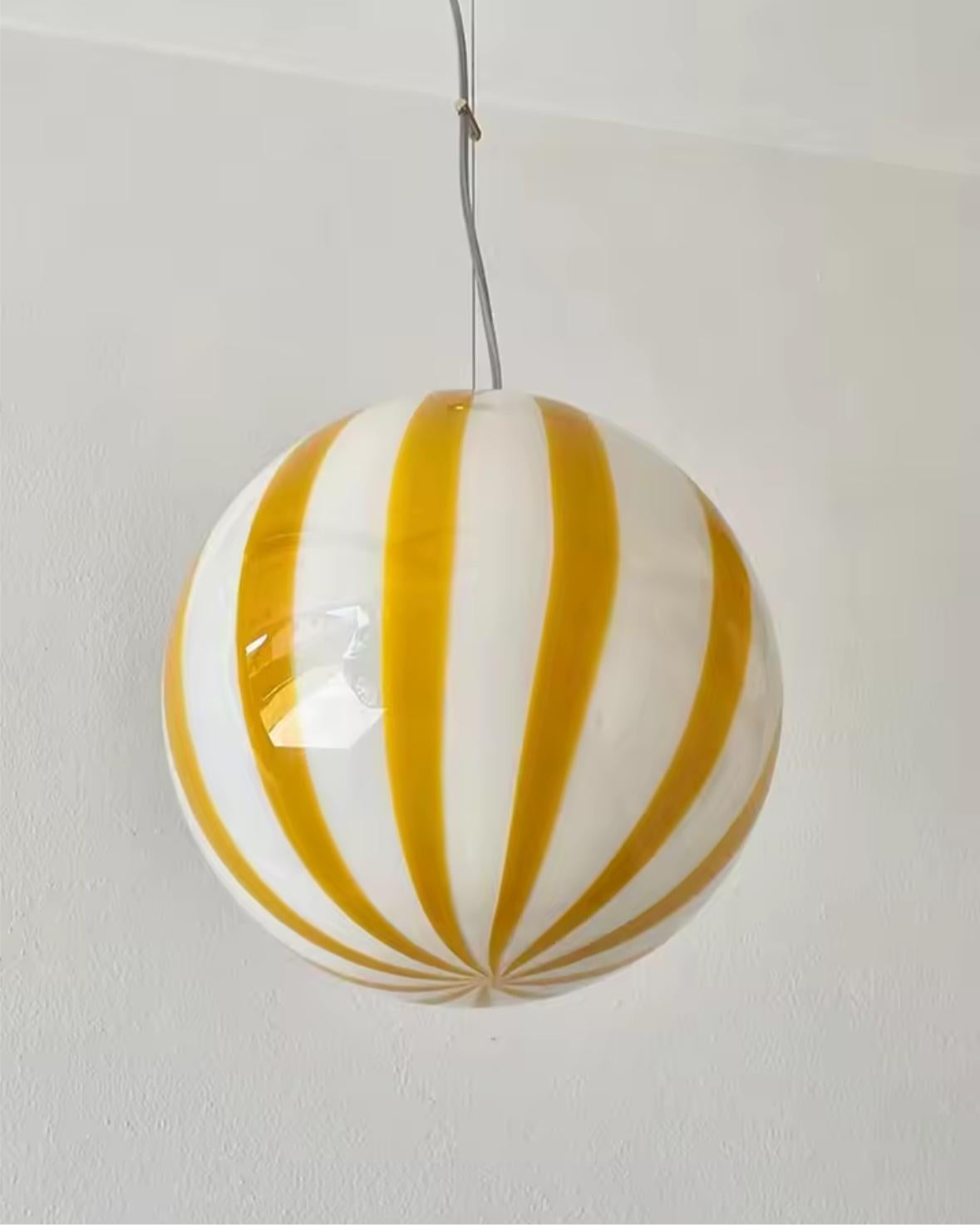 Designer murano glass lamp illuminated showing striped pattern