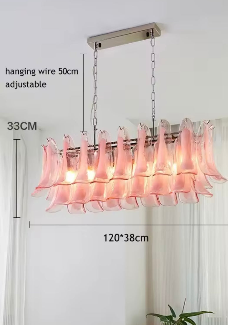 Handcrafted pink petal glass chandelier suspended over dining table