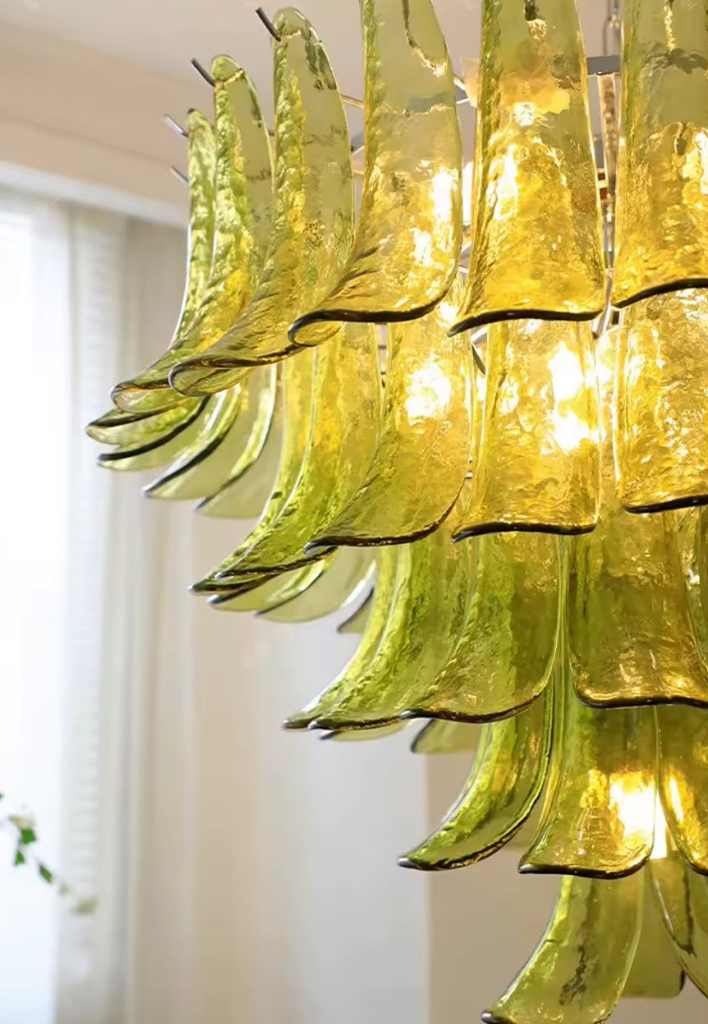 Murano chandelier with cascading emerald glass elements and warm lighting