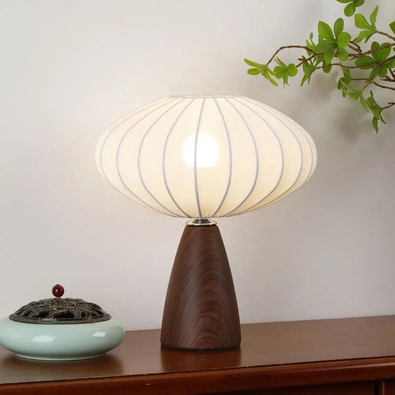 Designer table lamp creating warm ambient lighting on bedside table