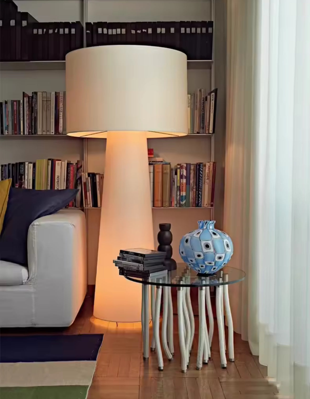 Designer floor lamp in bedroom corner creating cozy reading atmosphere