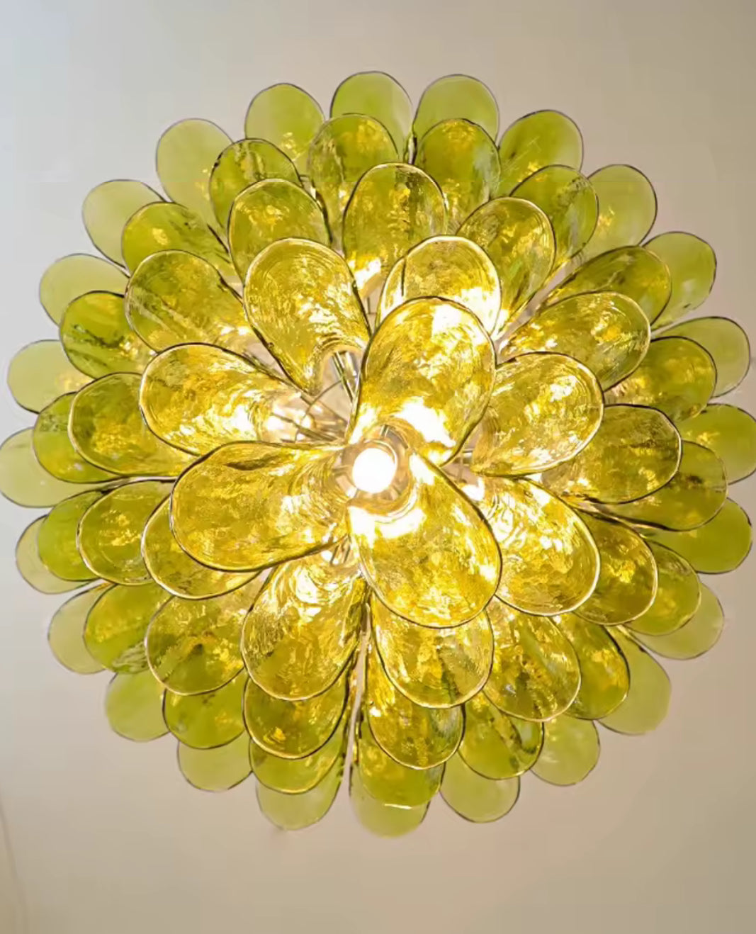 Statement green glass chandelier as focal point in modern living space