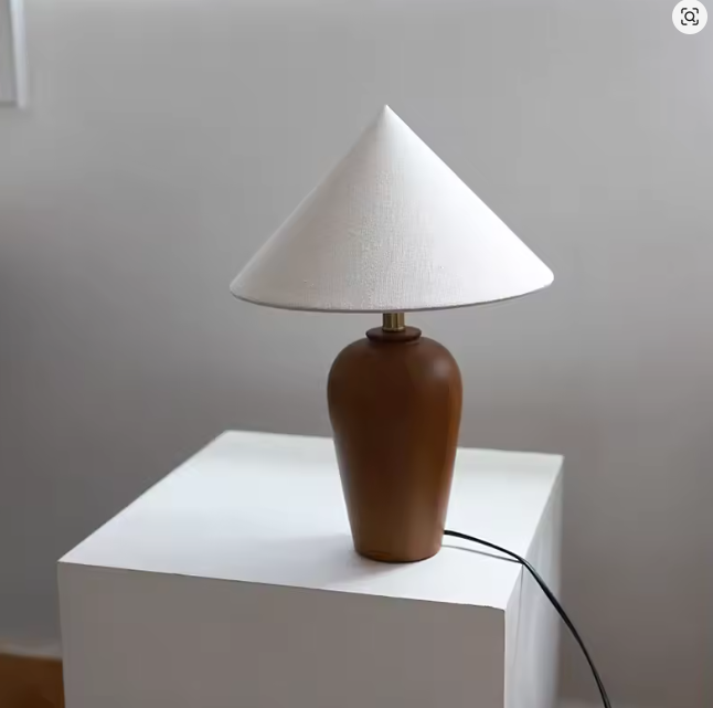 Danish Bauhaus walnut table lamp illuminated on modern workspace