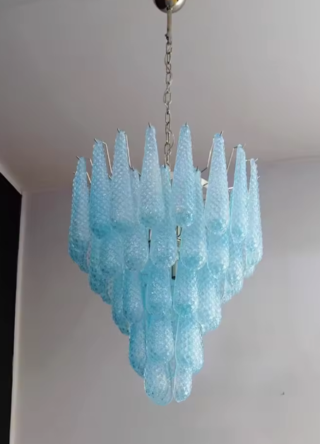 Close-up handcrafted blue murano glass drops on polished chrome framework