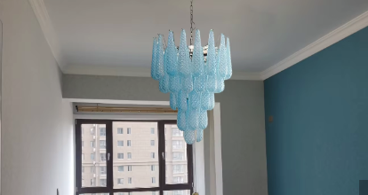 Illuminated blue italian glass lamp creating ambient dining room lighting