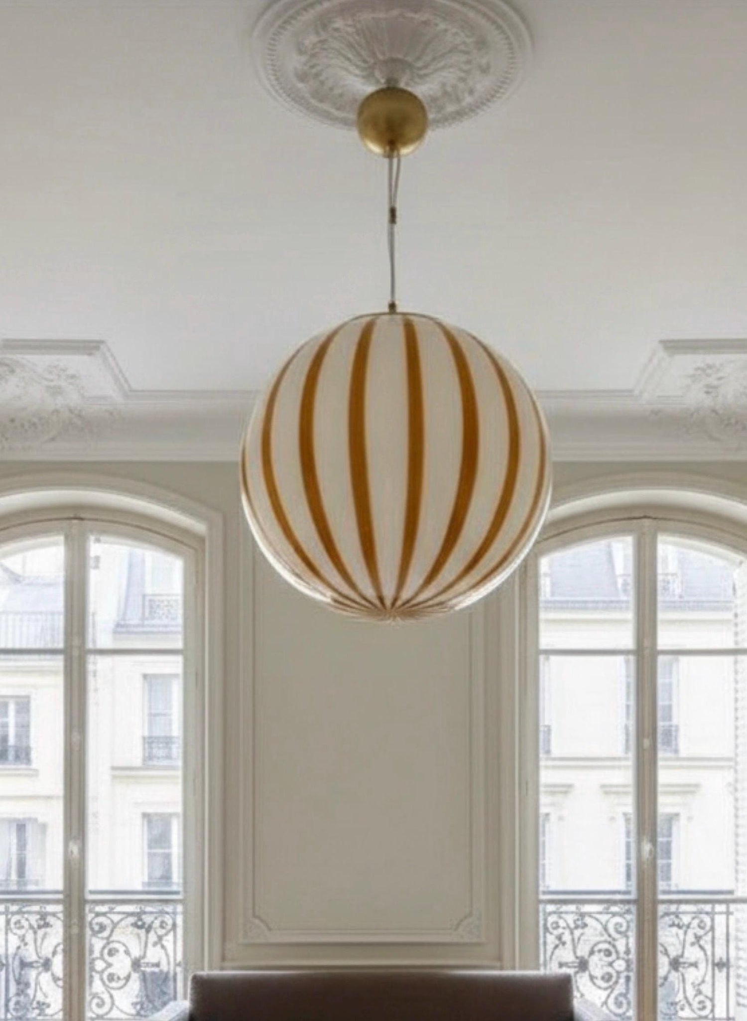 Murano glass pendant light with striped design in modern dining room
